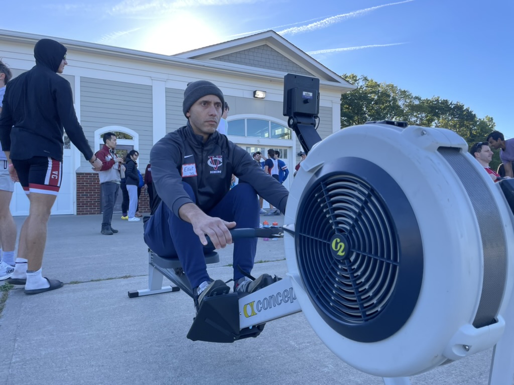 An alumnus on the erg outside the boathouse